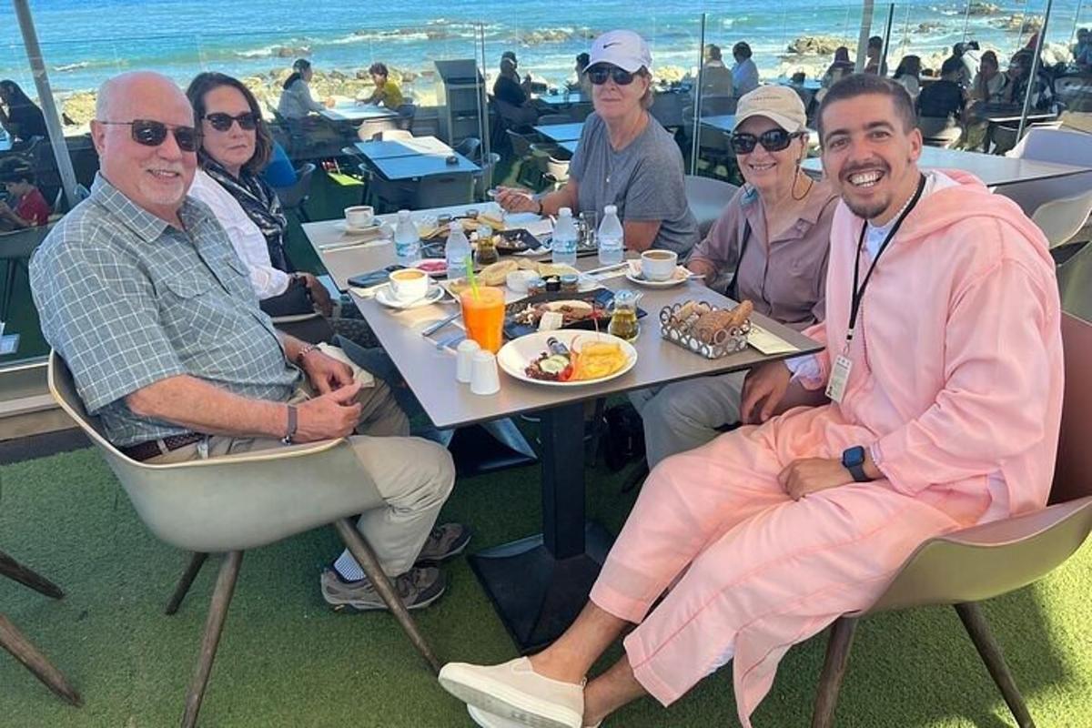 a group of people sitting at a table eating food