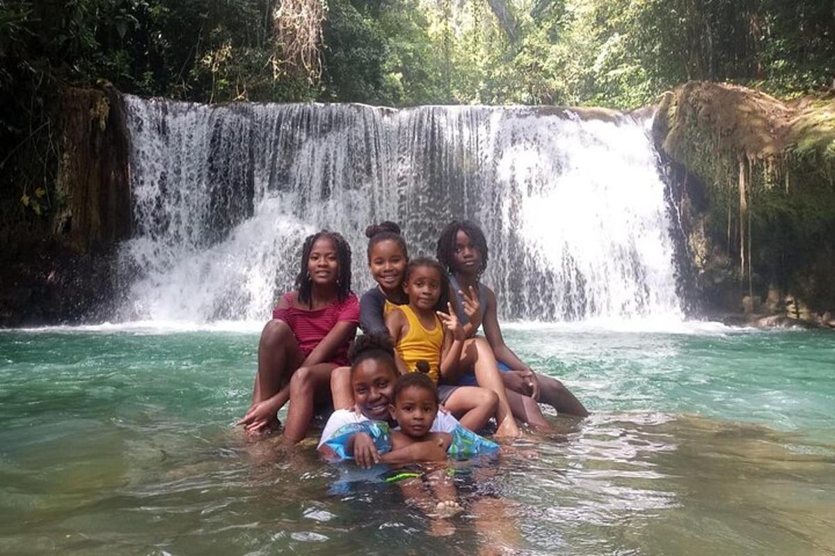 un gruppo di bambini seduti davanti a una cascata