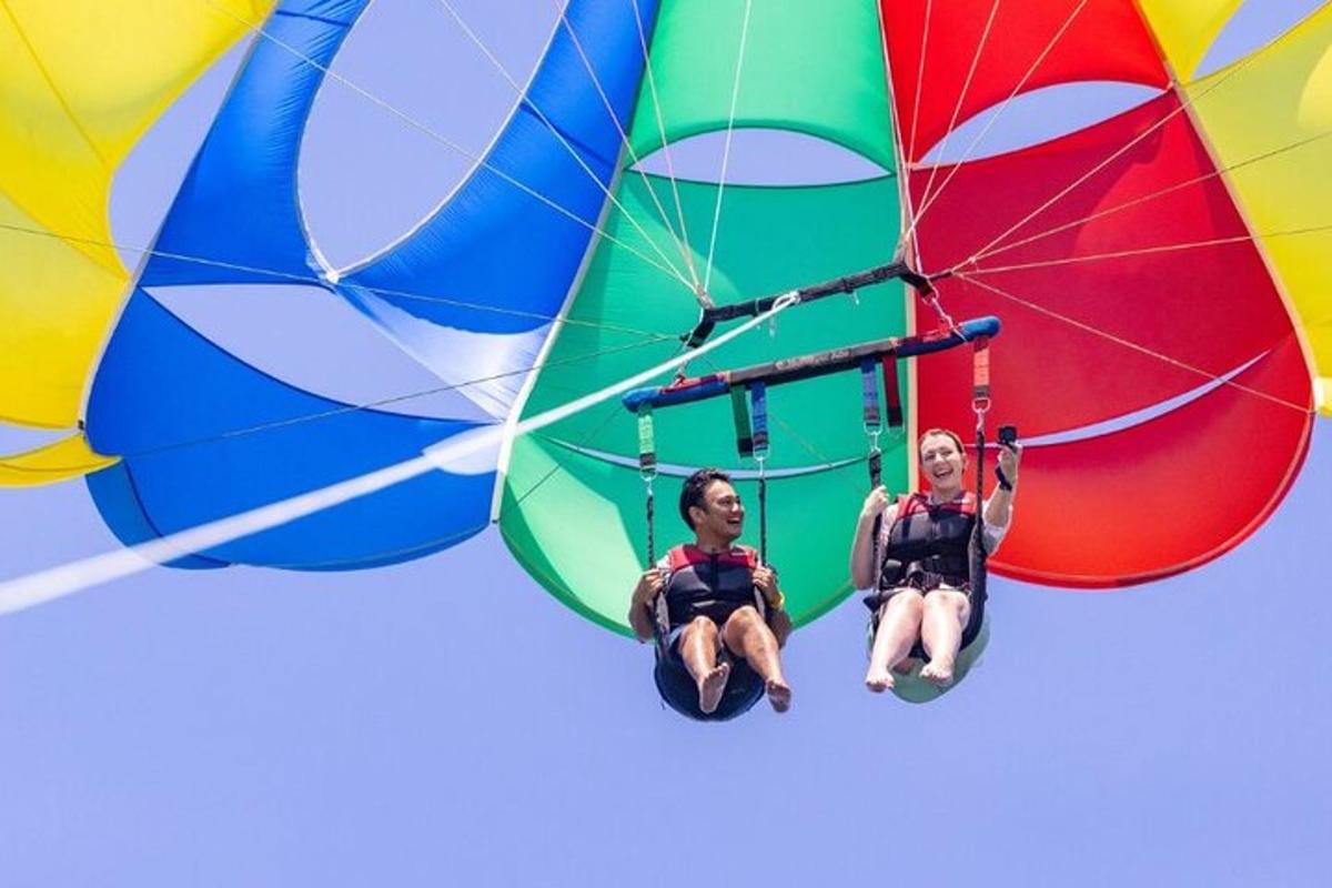 two men are sitting on a parachute