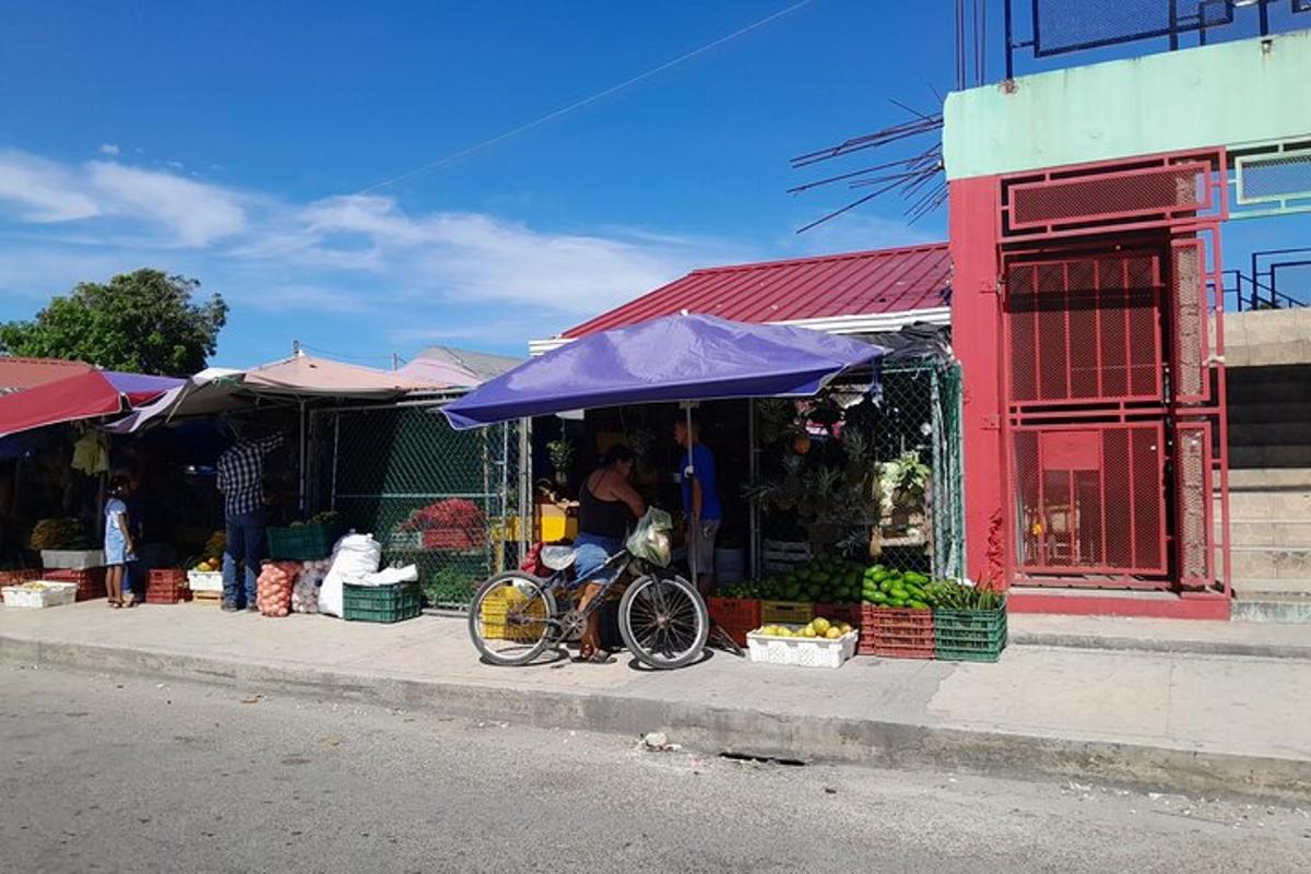 a bike parked in front of a fruit and vegetable stand