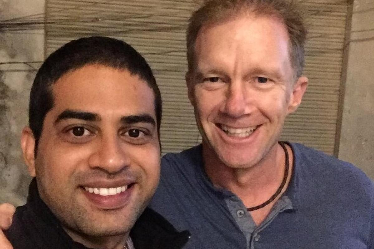 two men are posing for a picture together