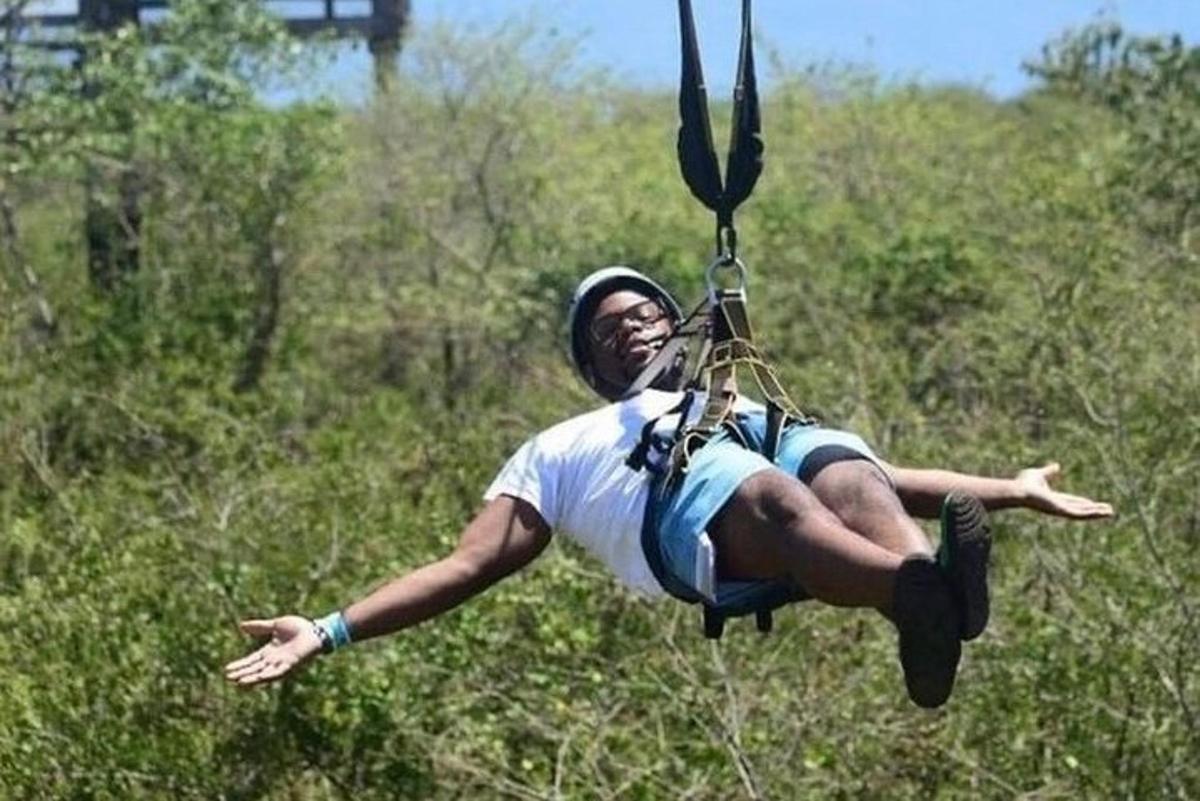 a man is hanging from a parachute
