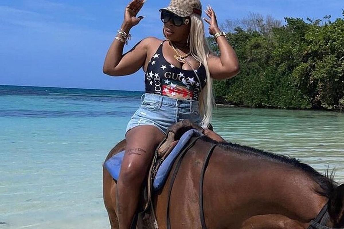 a woman is riding a horse on the beach
