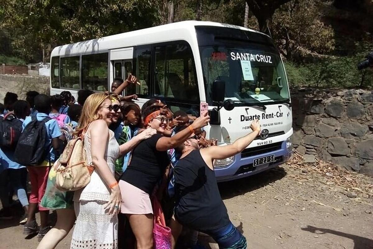 a group of people standing in front of a bus