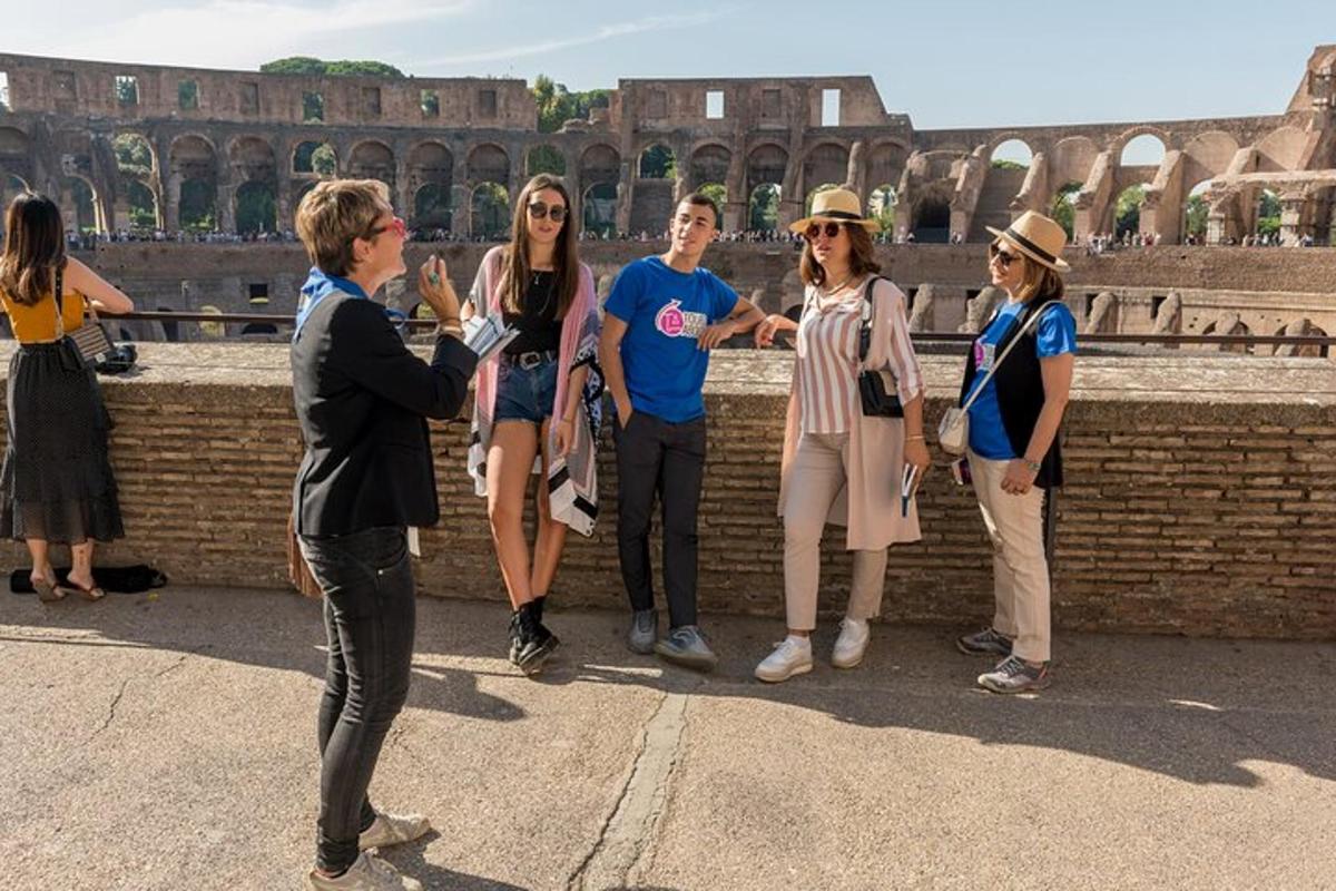 a group of women standing in front of the coliseum