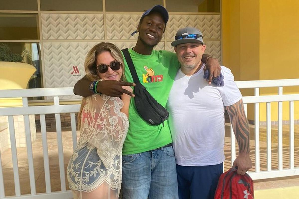 two men and a woman posing for a picture