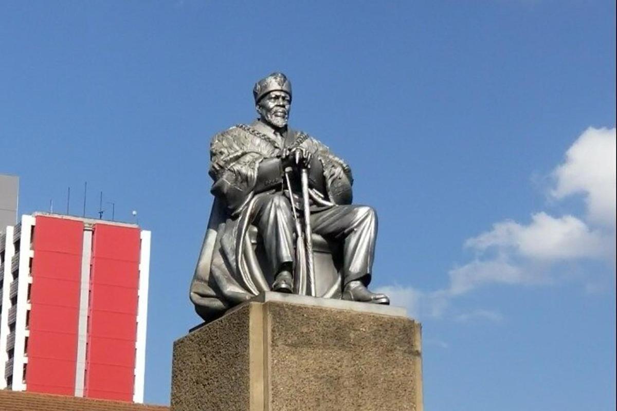 a statue of a man sitting on a motorcycle