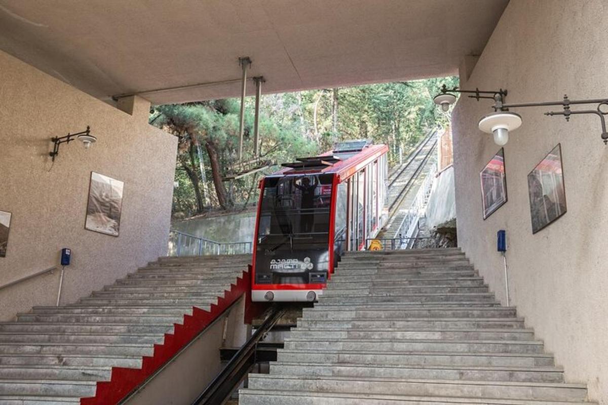 a red train is coming down the tracks