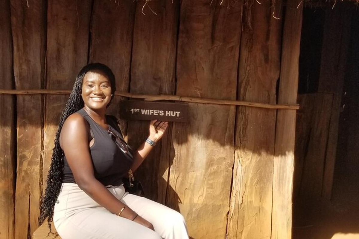 a woman is sitting next to a wooden wall