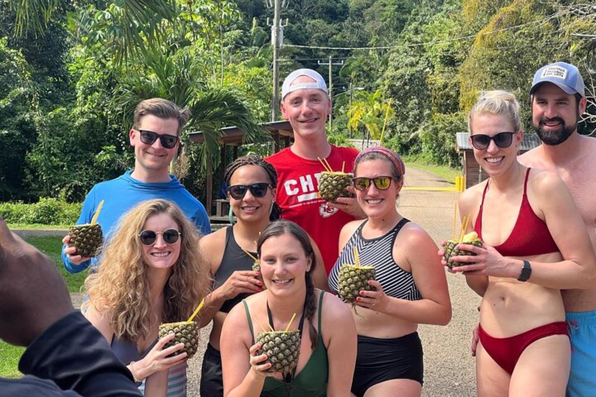 a group of people posing for a picture with pineapples