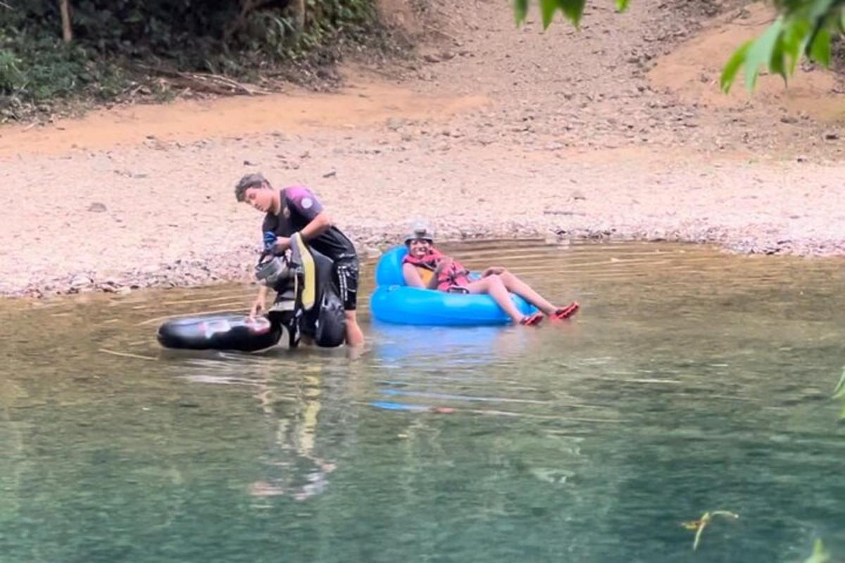 a man and a woman and a dog on a raft in the water