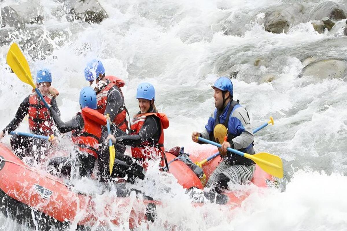 a group of people in a raft in a river