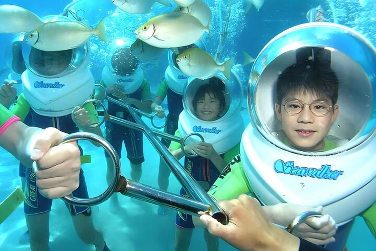 a group of people in an aquarium with a diver