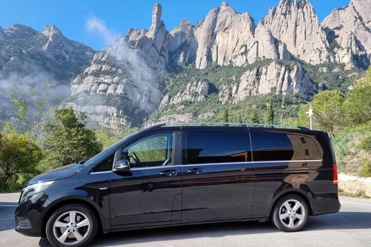 a black van parked in front of a mountain