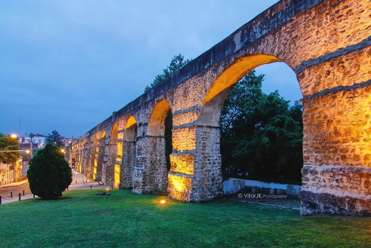 un vell pont de maó amb un arc a la nit