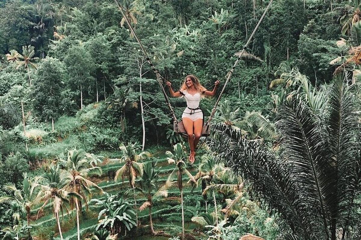 a woman on a rope swing in the jungle