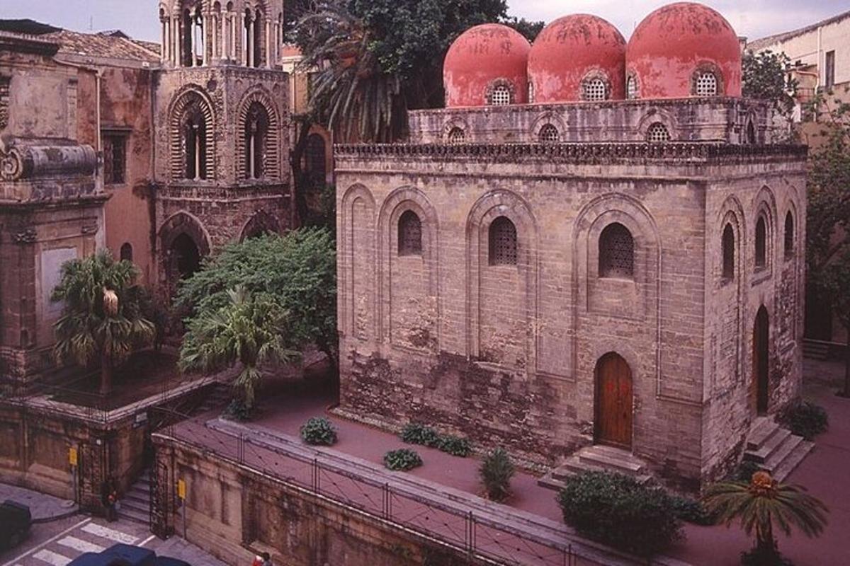 an old building with red domes on top of it