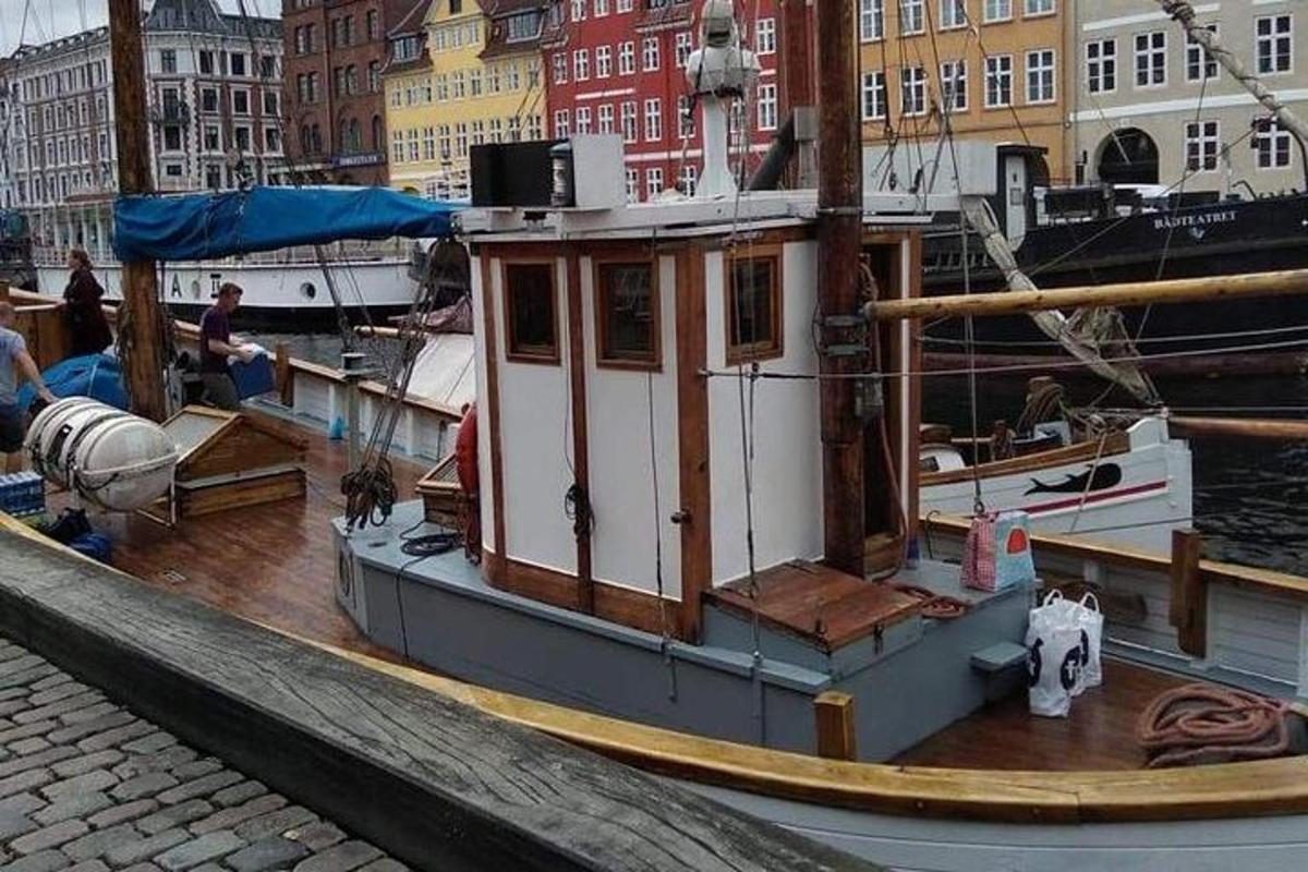 a small boat is docked at a dock