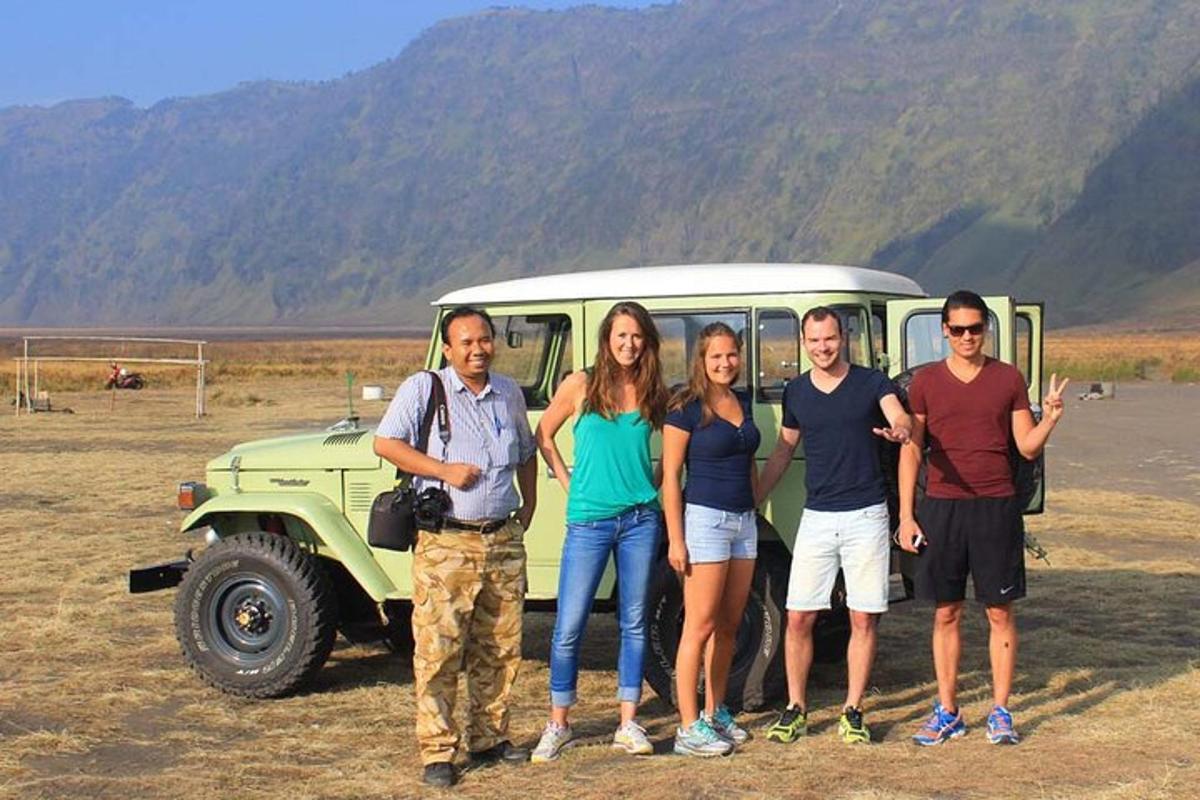 a group of people standing in front of a vehicle