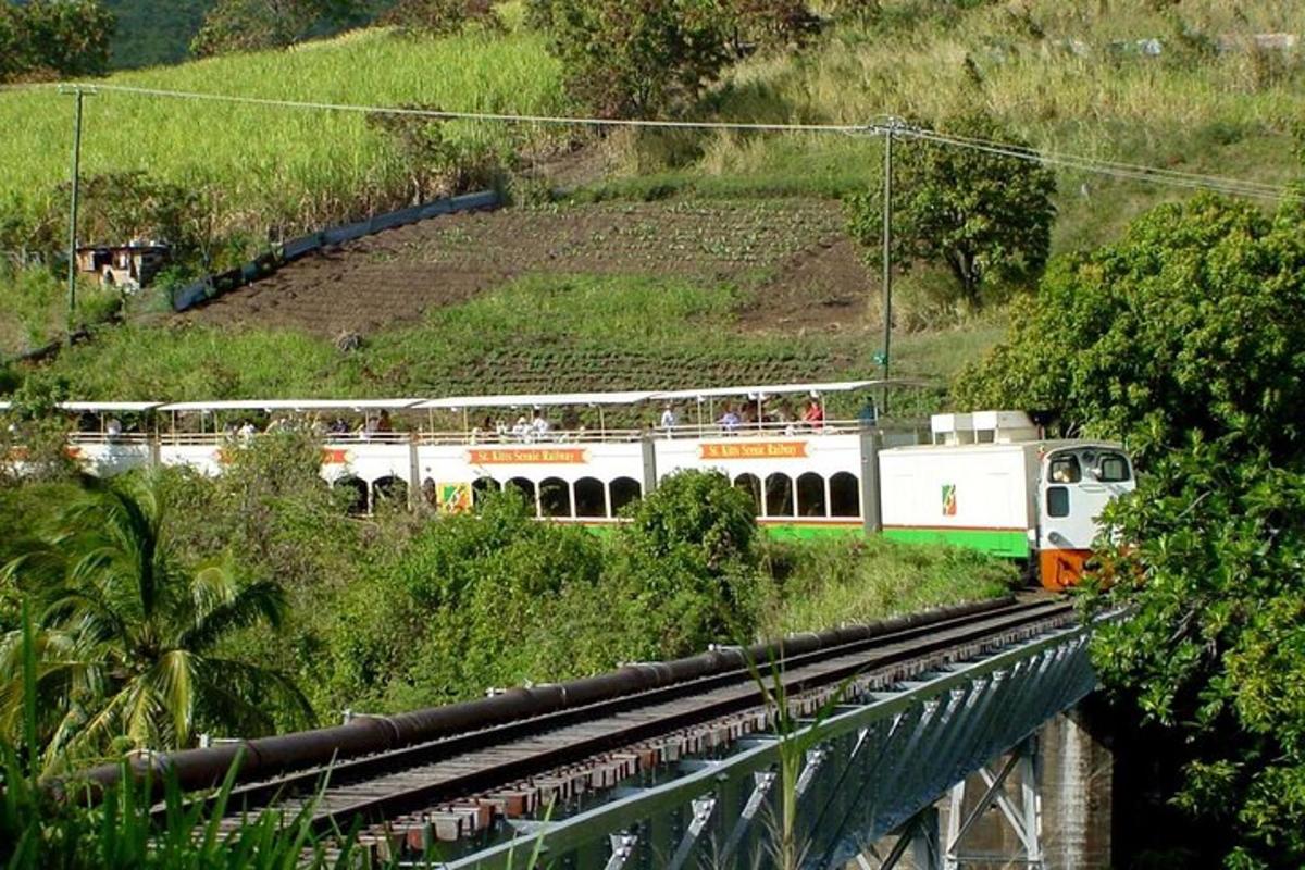 a white train traveling down a track on a hill