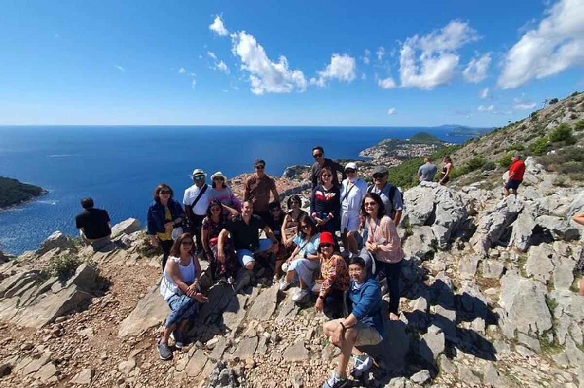a group of people posing for a picture on a mountain