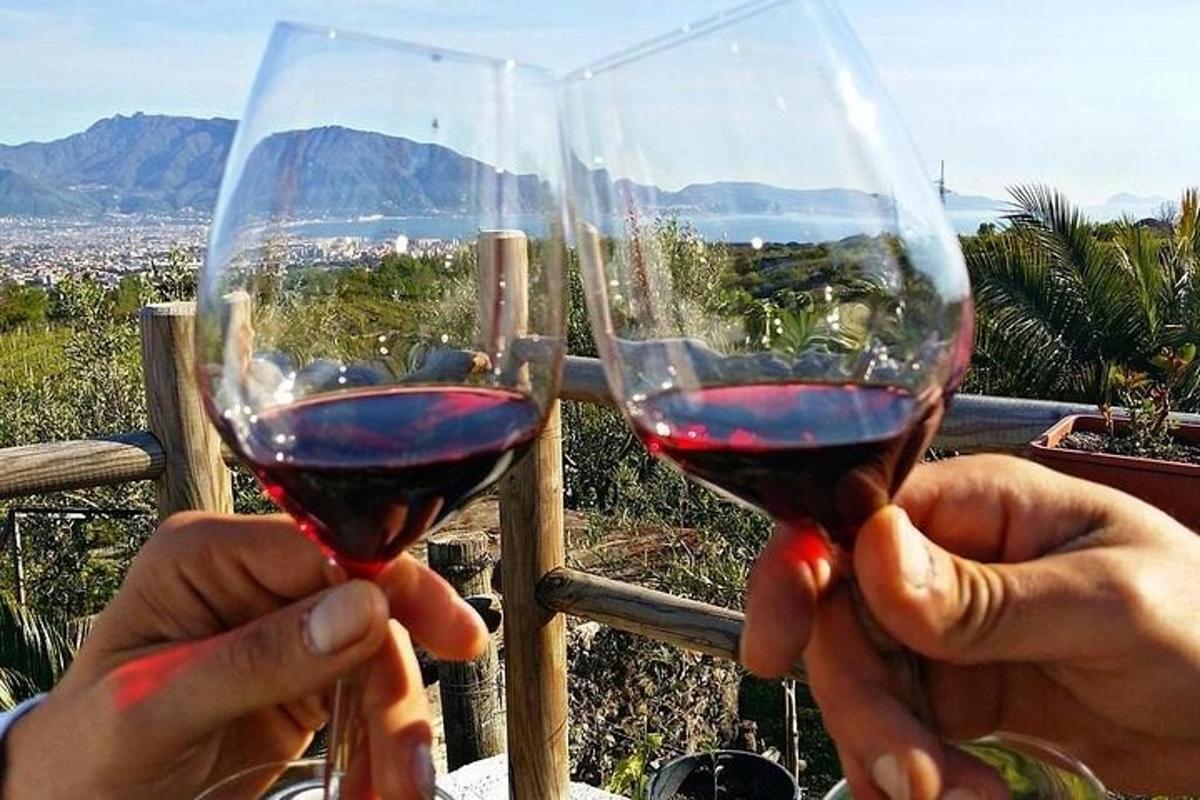 two people holding up glasses of red wine