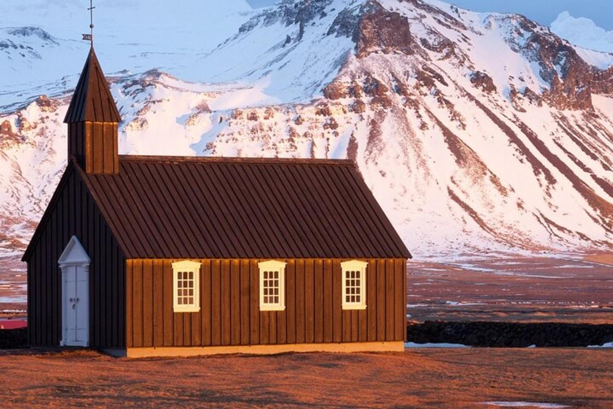 lítil kirkja með fjalli í bakgrunni
