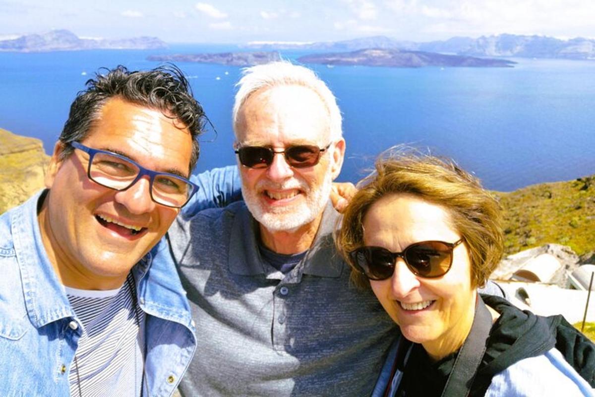 two men and a woman posing for a picture