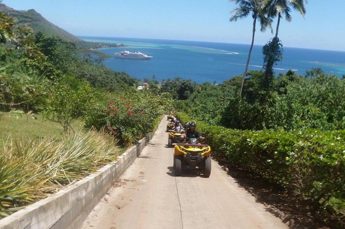 a group of people riding motorcycles down a dirt road