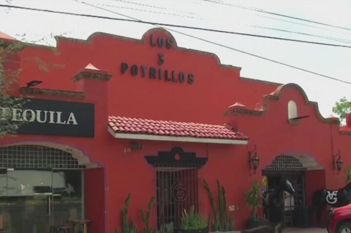 Un edificio rojo con un cartel de restaurante.