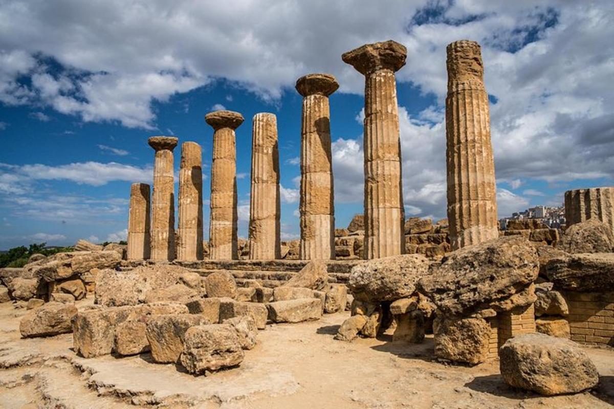 un gruppo di antiche colonne in un campo con rocce