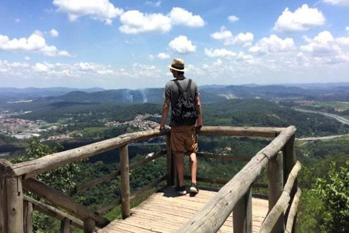 a man standing on top of a wooden boardwalk