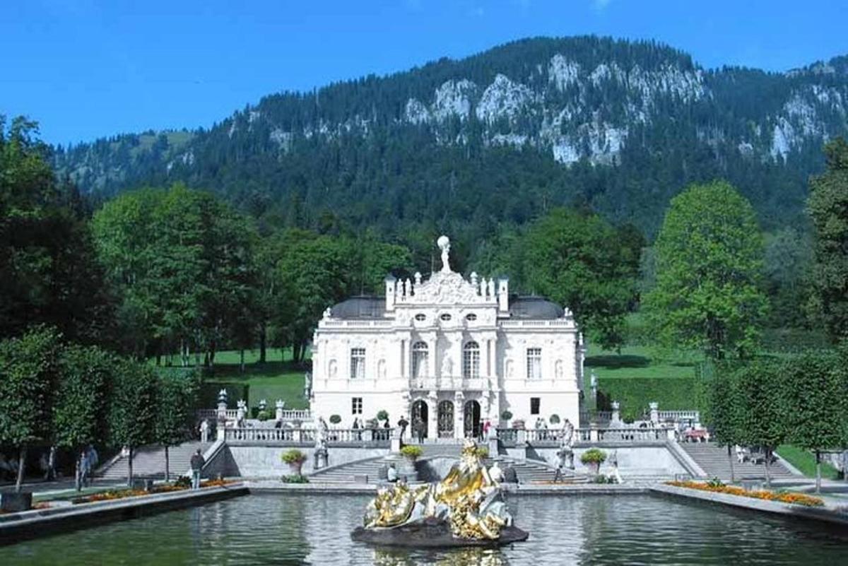 a large white building with a pond in front of it