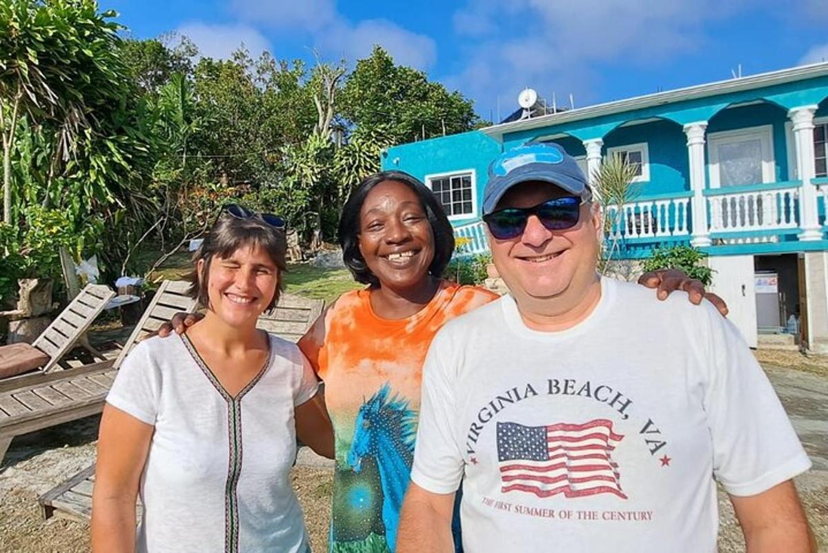 a man and two women standing in front of a house