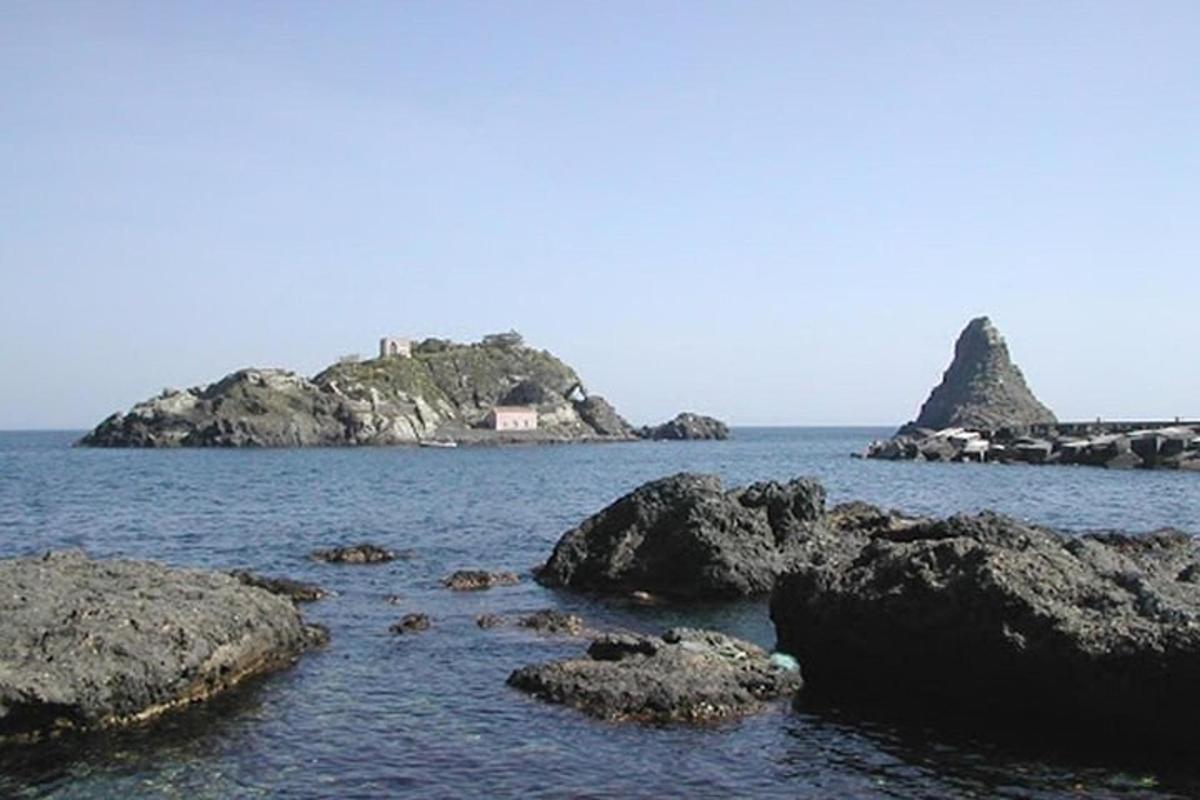 an island in the ocean with rocks in the water