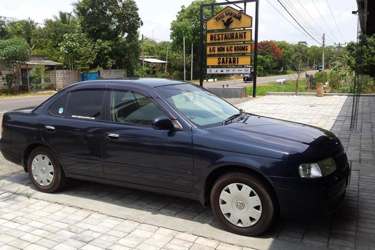 a blue car parked on the side of a street