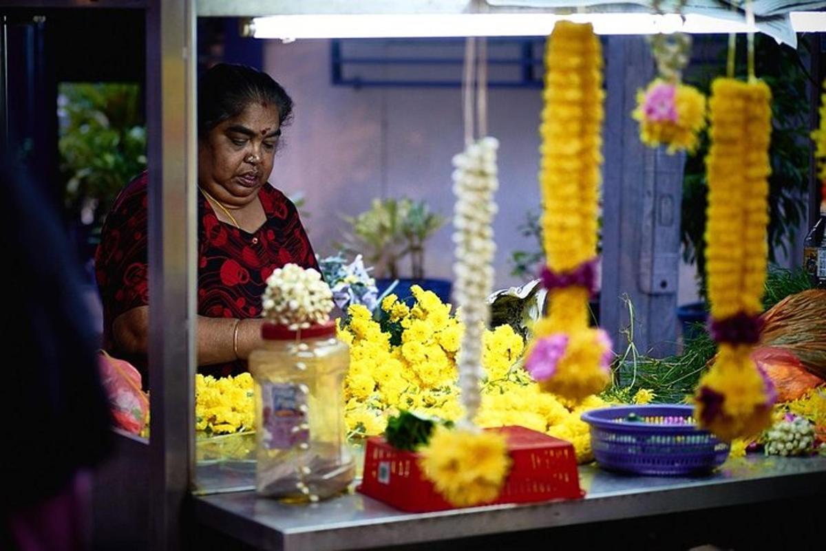 a woman standing behind a counter with flowers