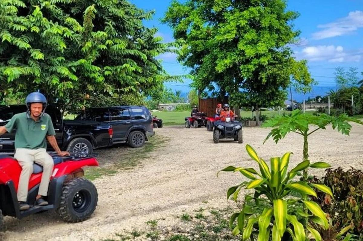 a man riding a four wheeler on a dirt road