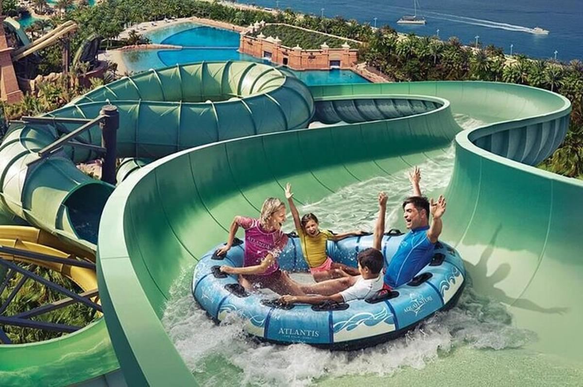 a group of people riding a water slide at a water park