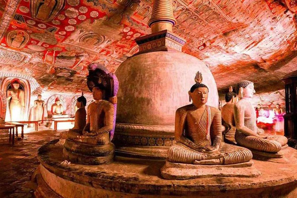 a group of statues sitting around a fountain in a cave