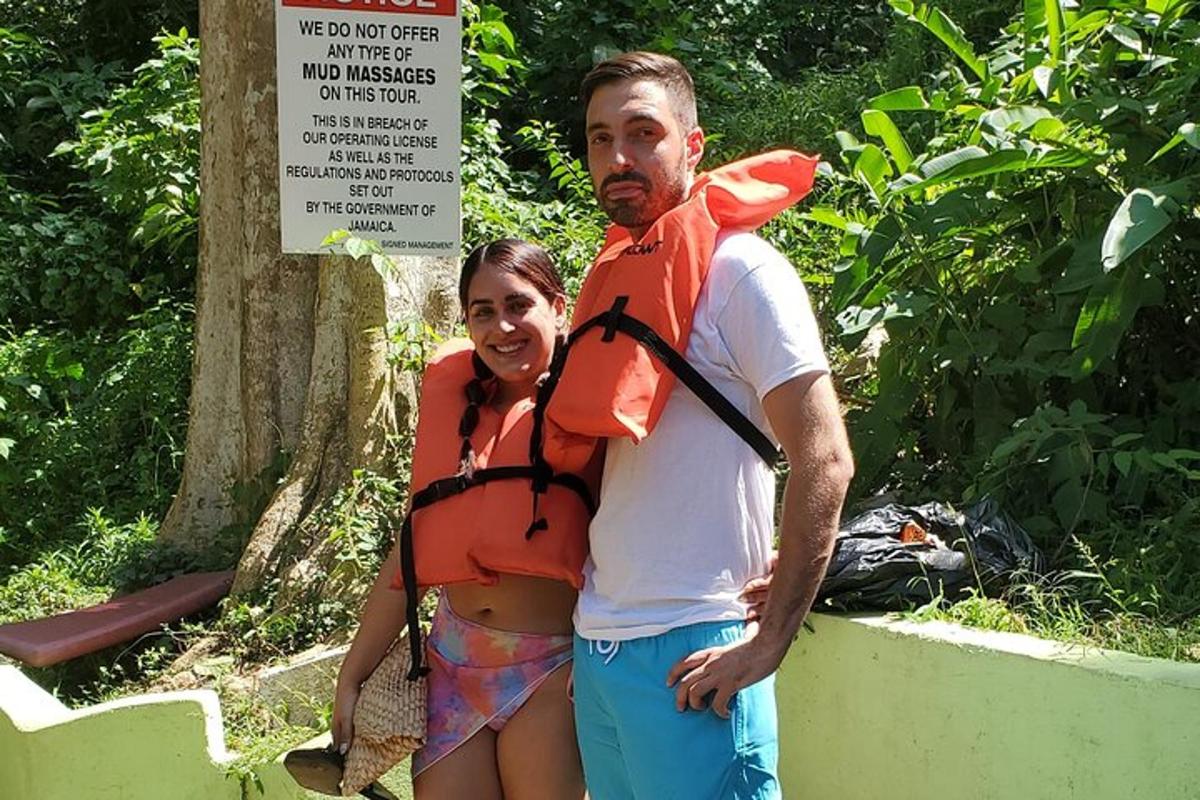 um homem e uma mulher em pé ao lado de uma placa