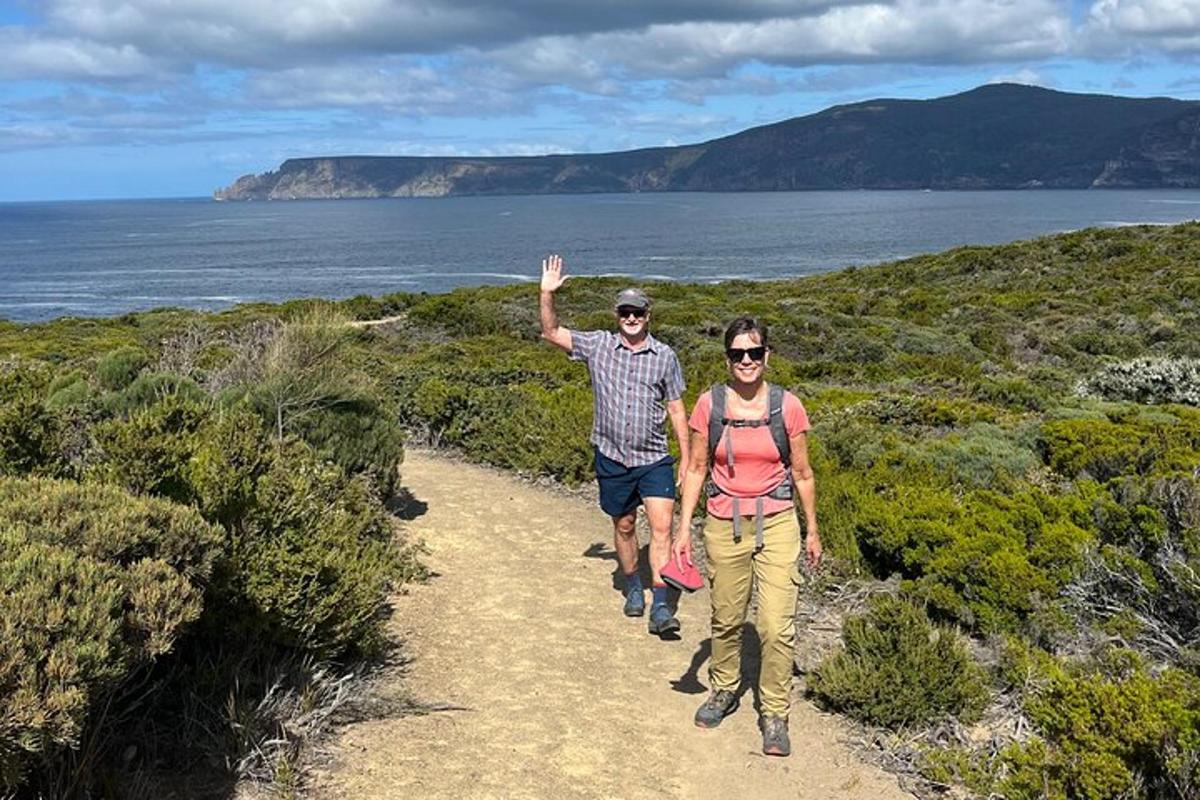 a man and a woman walking down a trail