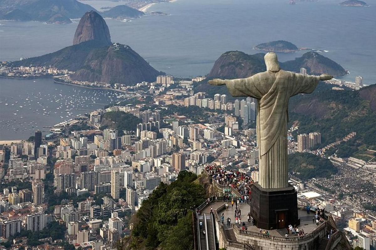 a statue of christ the redeemer on top of a city