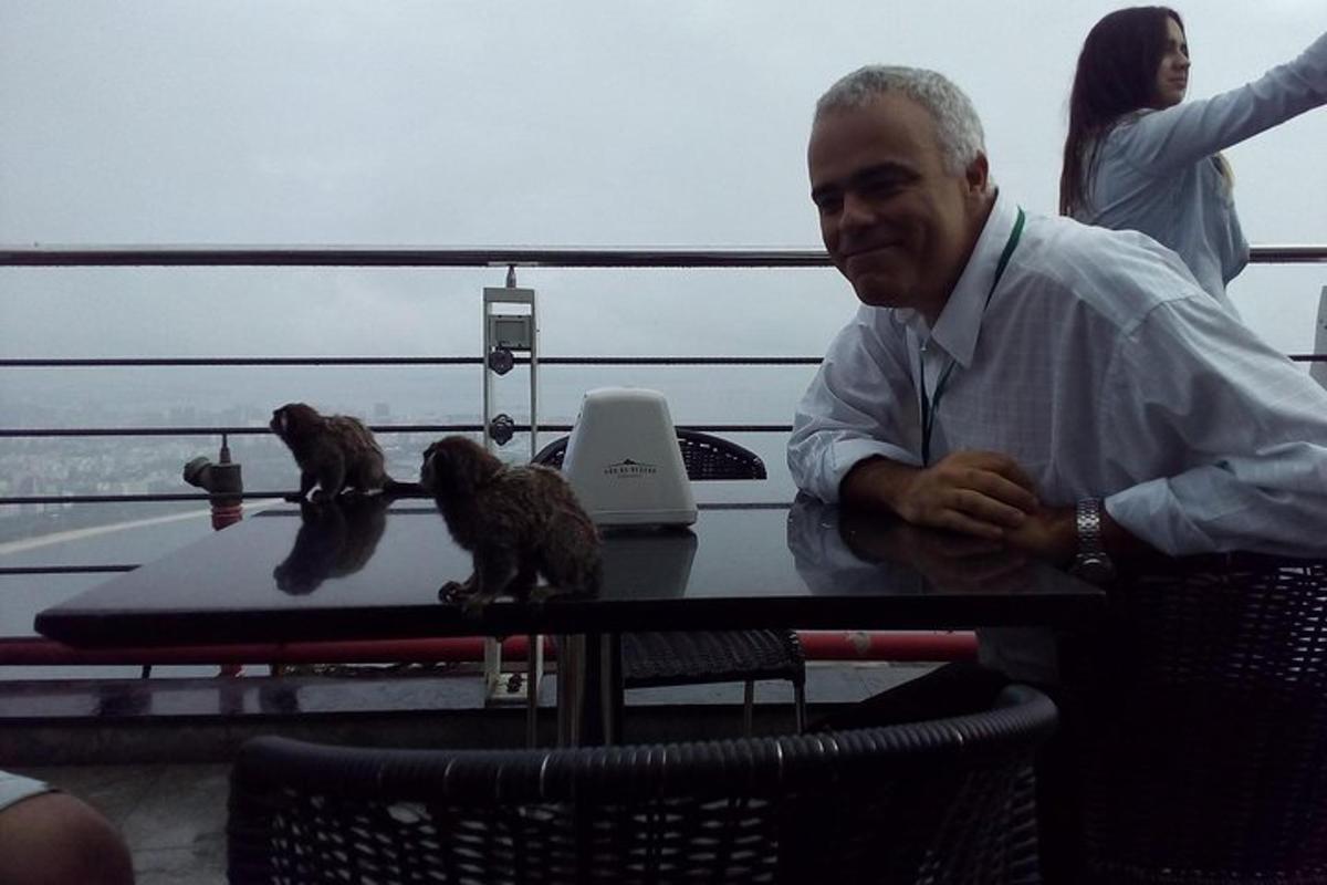 a man sitting at a table on a boat with birds