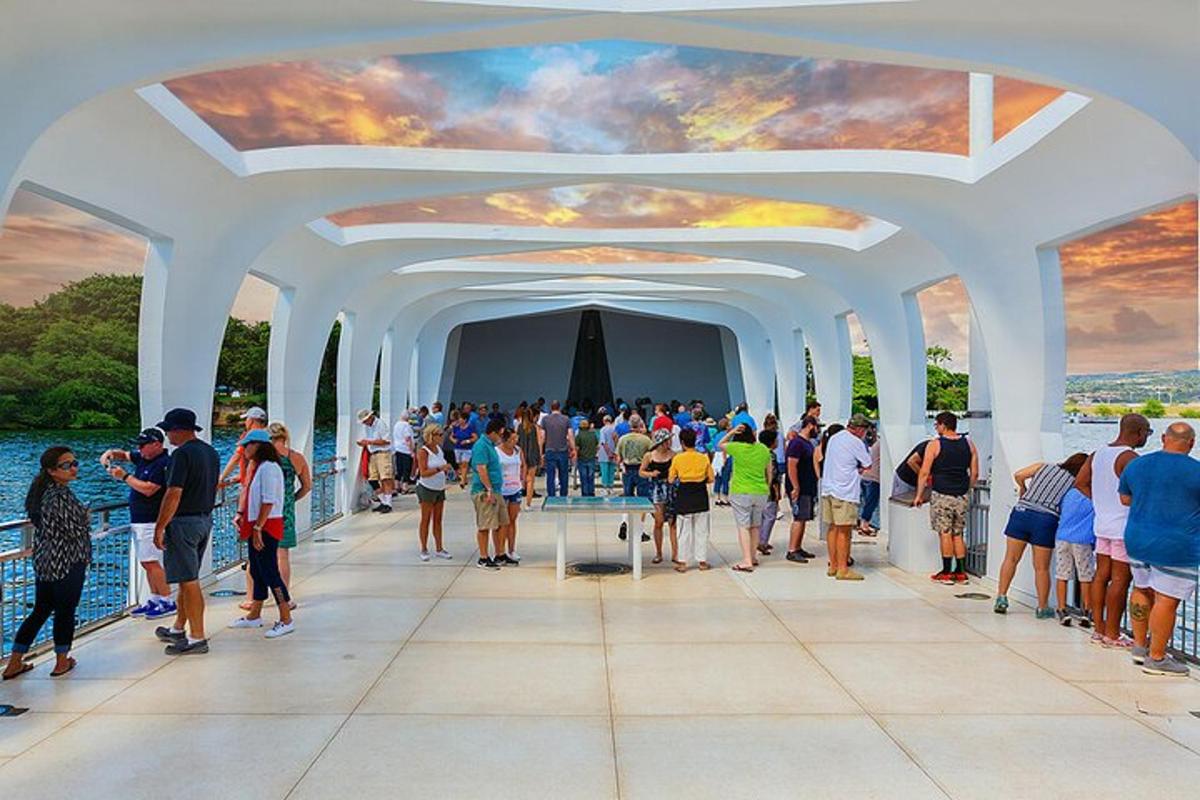 a large crowd of people standing in a white archway