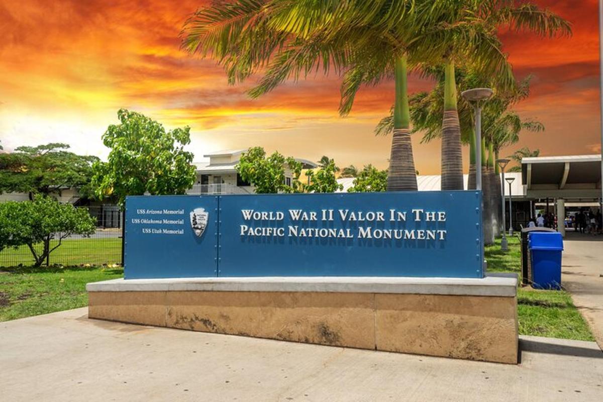 a sign in front of a building with palm trees