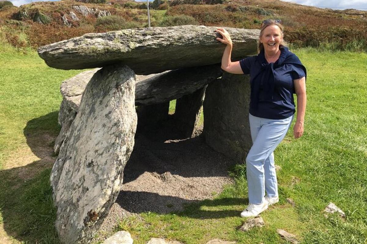 una dona està dreta al costat d'una gran roca