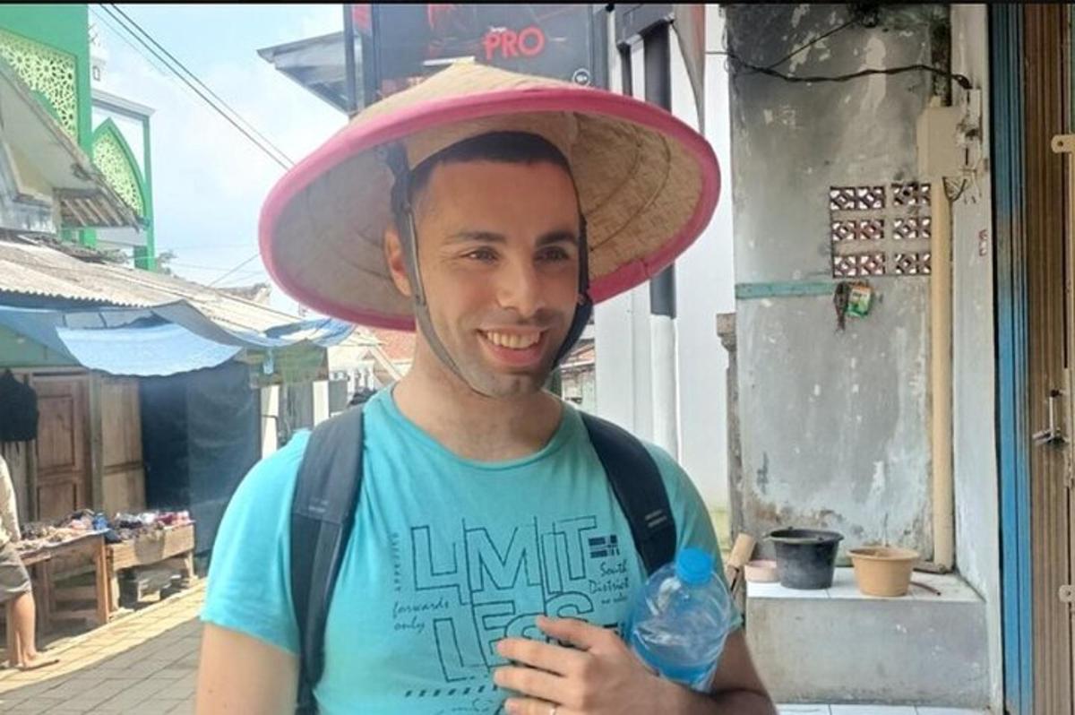 a man wearing a sombrero with a bottle of water