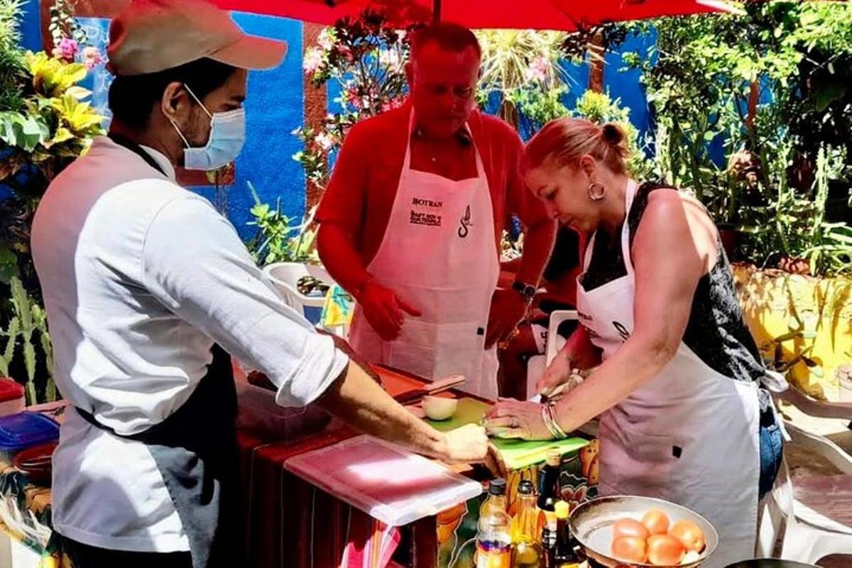 a man and a woman preparing food in a kitchen
