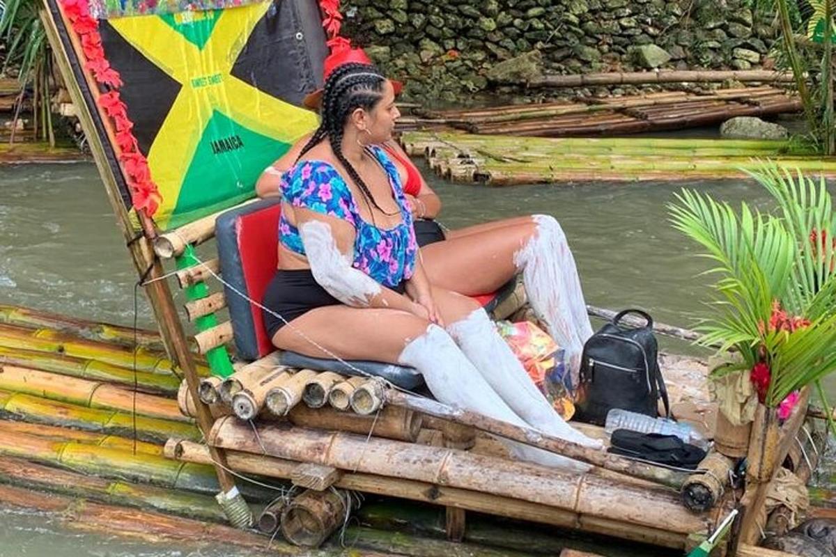 a woman sitting on the back of a bamboo boat
